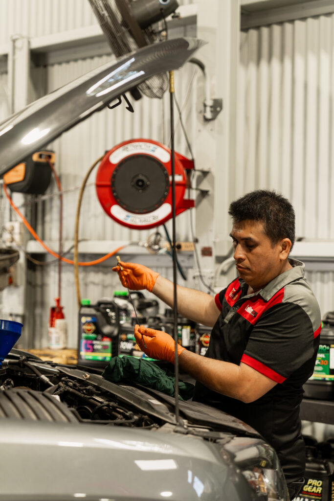 "Car air conditioning Brisbane regas equipment showing R134a and HFO-1234yf refrigerant gauges during automotive AC service